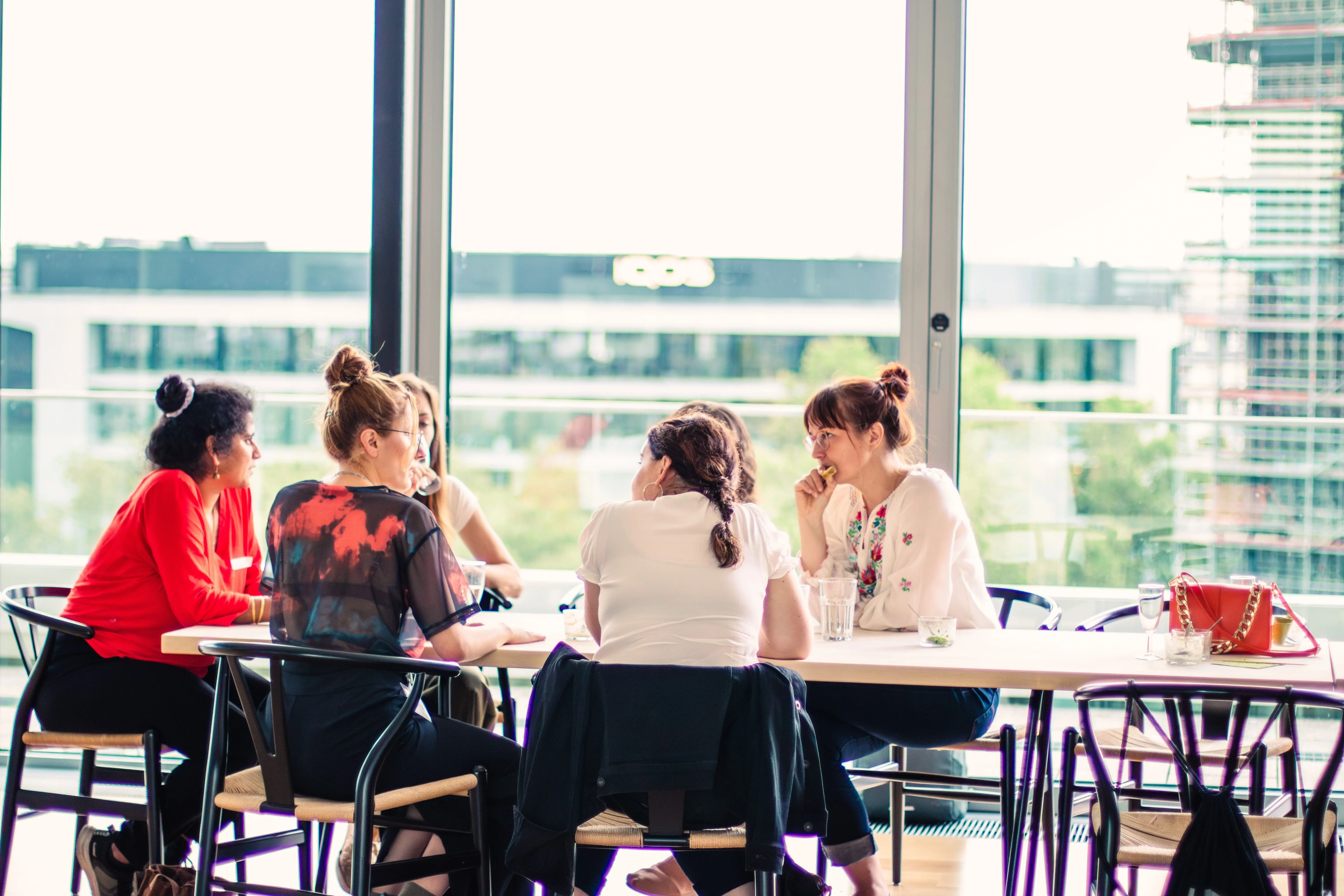 Radia Hero Image having a conversation at a table at the office